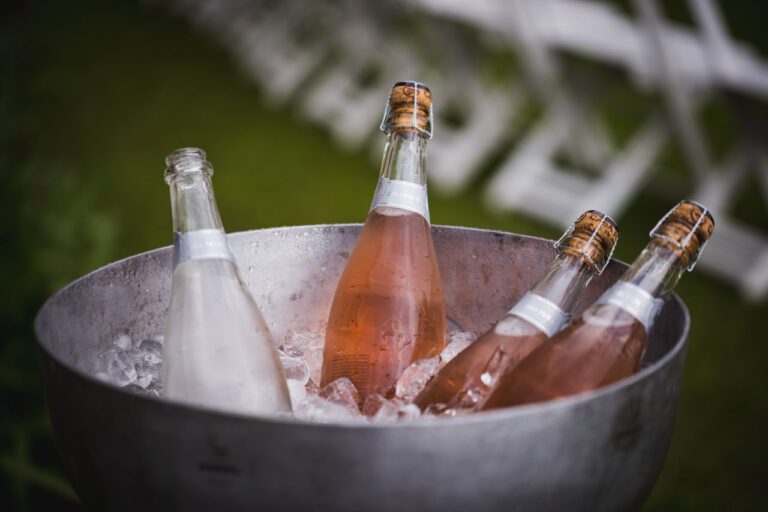Four champagne bottles chilling in an ice bucket, perfect for celebrations or events.
